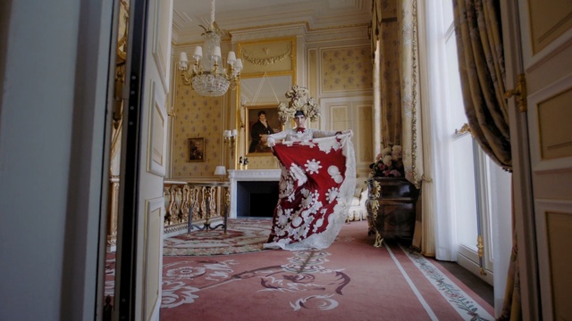 Video Reference: Room, Red, Interior design, Property, House, Building, Furniture, Architecture, Floor, Textile, Person