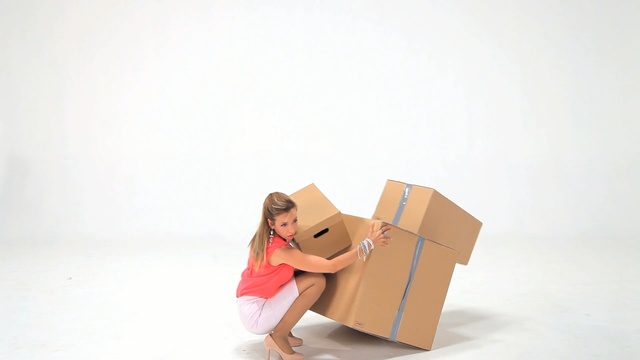 Video Reference: Cardboard, Pink, Carton, Box, Sitting, Paper product, Packaging and labeling, Paper bag, Package delivery, Smile