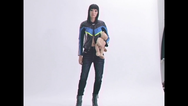 Video Reference: Clothing, Standing, T-shirt, Fashion, Outerwear, Jeans, Sleeve, Jacket, Shoulder, Trousers, Person, Man, Surfing, Holding, Suit, Posing, Board, Wearing, Snow, Woman, Skiing, Young, Smiling, Front, Black, Dressed, Water, Walking, White, Slope, Riding, Purple, Footwear, Trouser, Wet suit