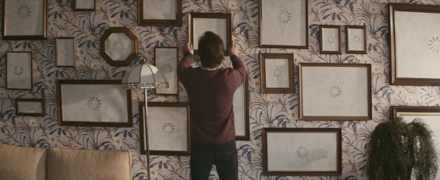 Video Reference: interior design, decor, pattern, picture frame, Person