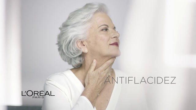 Video Reference: Face, Hair, Skin, Chin, Shoulder, Head, Beauty, Nose, Hairstyle, Neck, Person, Indoor, Woman, Holding, Lady, Looking, Mirror, Wearing, Standing, Front, Shirt, Man, Dress, White, Hand, Young, Glasses, Smiling, Room, Red, Teeth, Brushing, Wedding, Kitchen, Remote, Wall, Human face, Fashion accessory, Necklace, Portrait