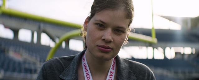 Video Reference: Smile, Photography, Person, Outdoor, Wearing, Looking, Man, Holding, Game, Woman, Front, Young, Standing, Red, White, Blue, Human face, Clothing, Face