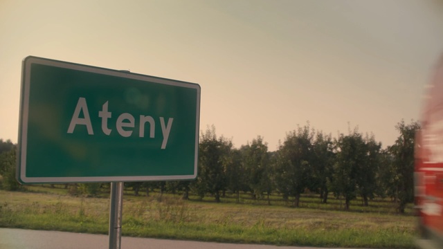 Video Reference: Green, Street sign, Signage, Sign, Road, Sky, Infrastructure, Traffic sign, Grass, Tree