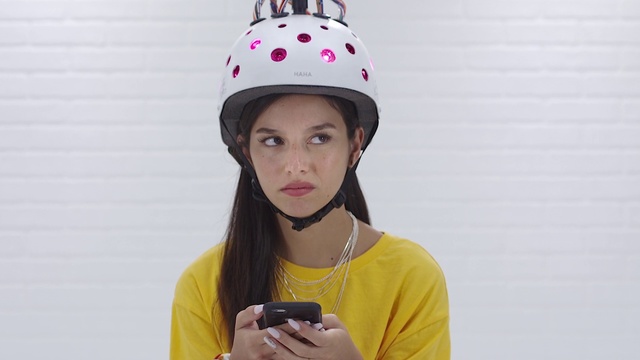 Video Reference: Helmet, Clothing, Beanie, Yellow, Personal protective equipment, Pink, Headgear, Knit cap, Hat, Fashion accessory