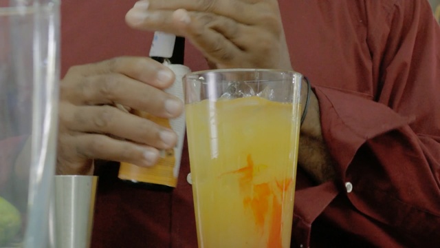 Video Reference: drink, juice, cocktail, alcoholic beverage, liqueur, harvey wallbanger, non alcoholic beverage, lemonade, Person