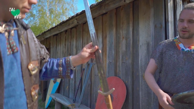 Video Reference: Art, Person, Outdoor, Building, Standing, Holding, Table, Cake, Food, Little, Woman, Young, Boy, Small, Man, Front, Plate, Carrying, Wearing, Knife, Cutting, Wooden, Birthday, Red, Pizza, Kitchen, Baseball, Hat, Bat, Shirt, White, Musical instrument, Violin