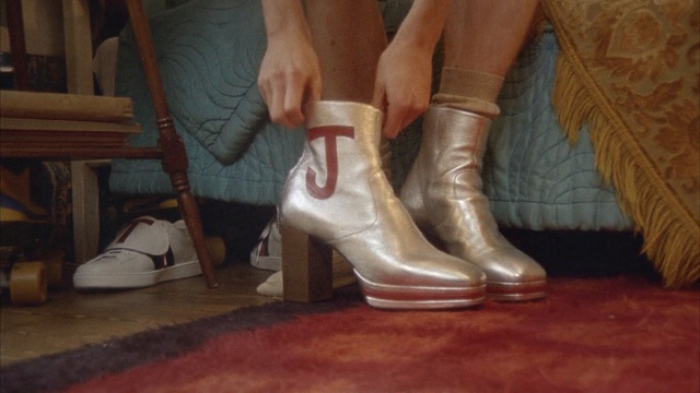 Video Reference: footwear, shoe, boot, leg, outdoor shoe, human leg, flooring, floor, foot, high heeled footwear, Person