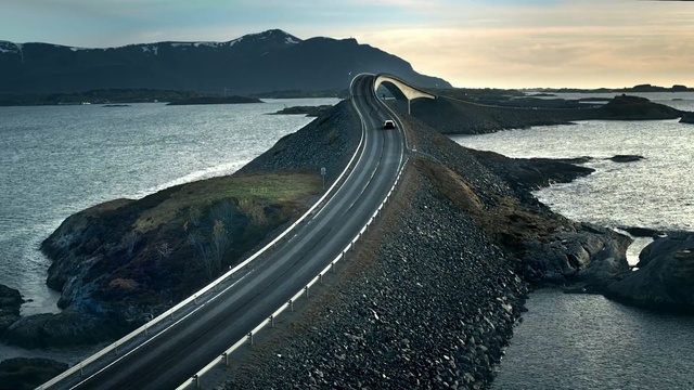 Video Reference: fixed link, road, sea, headland, sky, promontory, coast, horizon, coastal and oceanic landforms, loch