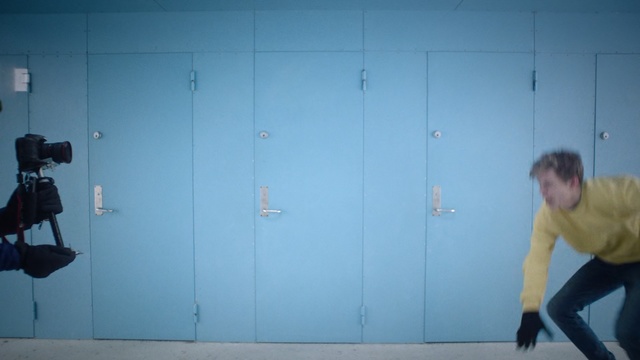 Video Reference: Blue, Wall, Standing, Shoulder, Yellow, Room, Joint, Arm, Leg, Physical fitness, Person