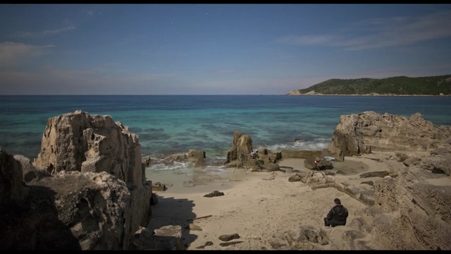 Video Reference: sea, coast, sky, body of water, rock, shore, coastal and oceanic landforms, horizon, promontory, ocean, Person