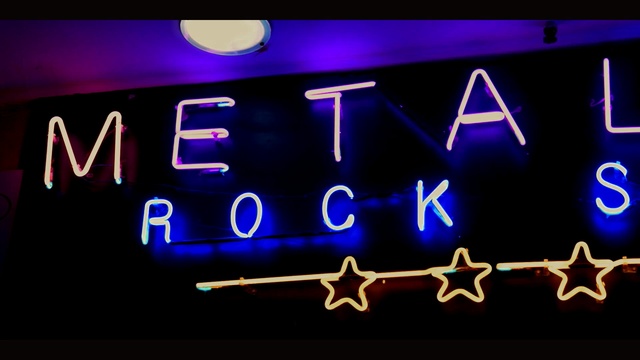 Video Reference: neon sign, light, neon, purple, electronic signage, signage, font, display device, Person