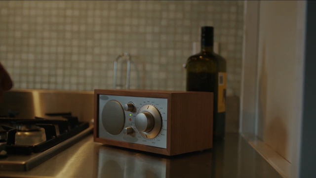 Video Reference: furniture, interior design, wood, flooring, still life photography, audio equipment, still life, loudspeaker, Person