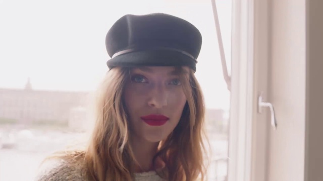 Video Reference: Hair, Clothing, Cap, Beanie, Lip, Hat, Headgear, Fashion accessory, Selfie, Baseball cap, Person, Wearing, Woman, Looking, Cake, White, Young, Holding, Dressed, Smiling, Black, Large, Phone, Standing, Man, Red, Snow, Blue, Human face, Fashion, Girl, Sun hat, Fedora, Face, Portrait