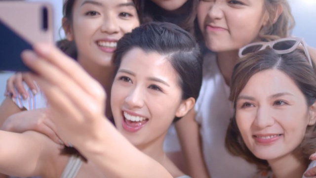 Video Reference: Skin, Facial expression, Selfie, Friendship, Smile, Fun, Youth, V sign, Photography, Happy, Person, Indoor, Young, Girl, Group, Woman, Posing, People, Sitting, Standing, Photo, Child, Table, Man, Holding, Smiling, Little, Cake, Talking, Room, Phone, White, Human face, Clothing, Bride, Wedding dress