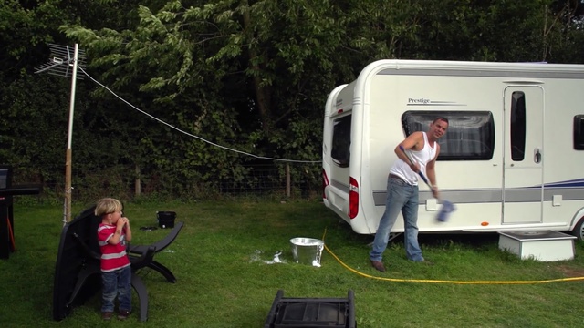 Video Reference: car, vehicle, camping, transport, travel trailer, caravan, trailer, recreational vehicle, recreation, plant, Person