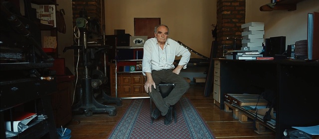 Video Reference: room, standing, electronic device, house, technology, furniture, audio, Person