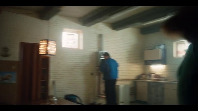 Video Reference: Property, Ceiling, Light, Wall, Standing, Snapshot, Room, House, Daylighting, Window, Person, Indoor, Man, Kitchen, Looking, Table, Woman, Mirror, Blurry, Living, Large, Television, Young, People, White, Sink, Riding, Stove, Door, Clothing