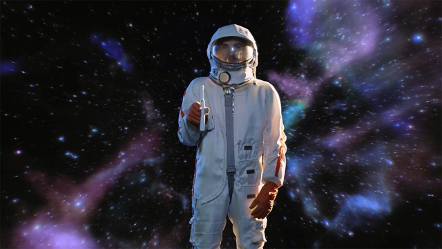 Video Reference: music artist, performance, atmosphere, competition event, space, sky, astronaut, public event, computer wallpaper, event, Person