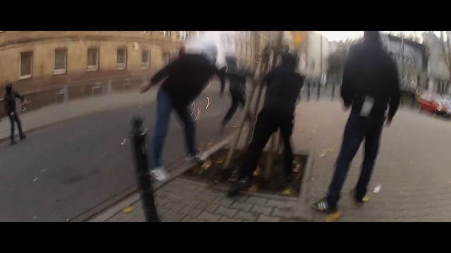 Video Reference: Snapshot, Mode of transport, Longboard, Pedestrian, Asphalt, Skateboard, Recreation, Photography, Skateboarding equipment, Vehicle, Outdoor, Walking, Road, Street, Cross, Sidewalk, Crossing, People, City, Riding, Holding, Group, Man, Wet, Carrying, Umbrella, Surfing, Standing, Board, Woman, Rain, Skiing, Train, Horse, Person, Footwear, Screenshot, Clothing, Text