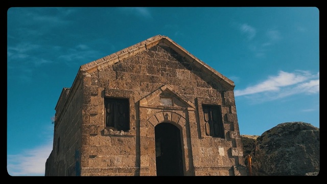 Video Reference: Sky, Blue, Architecture, Historic site, Arch, Building, Tree, Ancient history, Cloud, History, Person, Outdoor, Clock, Tower, Church, Stone, Window, Brick, Old, Large, Tall, Rock, Front, Mounted, Big, Sitting, Mountain, Face, Side, View, Cloudy, White, Standing, House, Door, Roof