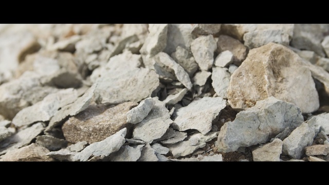 Video Reference: rock, bedrock, geology, gravel, rubble, material, igneous rock, mineral, outcrop, pebble, Person