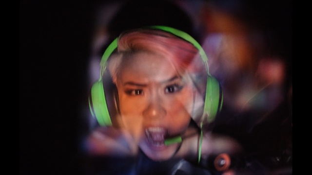 Video Reference: Face, Green, Head, Audio equipment, Headphones, Organ, Fun, Eye, Smile, Mouth, Person