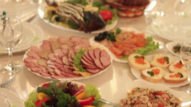 Video Reference: Dish, Food, Cuisine, Meal, Ingredient, Brunch, Cold cut, Buffet, Garnish, Finger food, Plate, Table, Filled, Different, Dinner, Woman, Wine, Sitting, Full, Many, Glasses, Bowl, Several, Holding, Eating, Bunch, People, Meat, White, Group, Rice, Fast food, Vegetable, Salad, Culinary art, Delicacy, Seafood, Baked goods, Delicious, Tomato