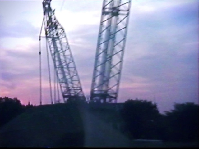 Video Reference: Sky, Overhead power line, Landmark, Tower, Transmission tower, Electricity, Morning, Cloud, Public utility, Atmosphere