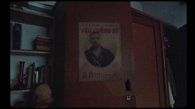 Video Reference: Brown, Font, Shelf, Signage, Event, Tie, Room, Visual arts, Bookcase, Advertising