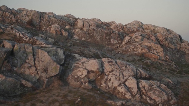 Video Reference: Rock, Bedrock, Outcrop, Mountainous landforms, Geology, Formation, Geological phenomenon, Igneous rock, Badlands, Boulder, Rocky, Mountain, Outdoor, Stone, Standing, Giraffe, Area, Sitting, Pile, Black, Enclosure, Zoo, Large, Field, Perched, Sheep, Zebra, White, Wall, Desert, Sky