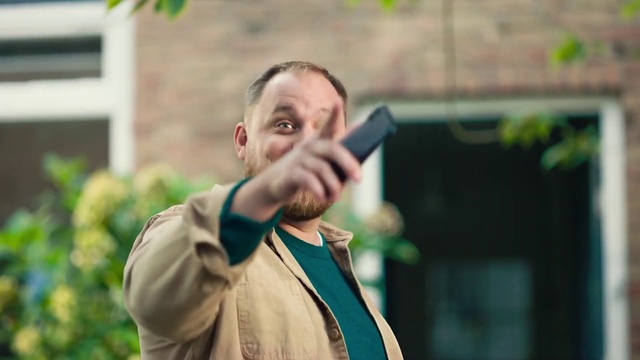 Video Reference: Outerwear, Plant, Gesture, Happy, Beard, Eyewear, Street fashion, Facial hair, Formal wear, Grass