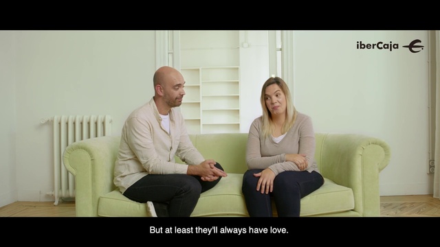Video Reference: Photograph, Sitting, Conversation, Blond, Photo caption, Room, Couch, Photography, Happy, Furniture, Person, Indoor, Woman, Window, Looking, Man, Holding, Table, Front, Using, Black, Laptop, Standing, Computer, Young, Phone, Suit, White, People, Clothing, Wall, Human face, Smile, Text, Screenshot