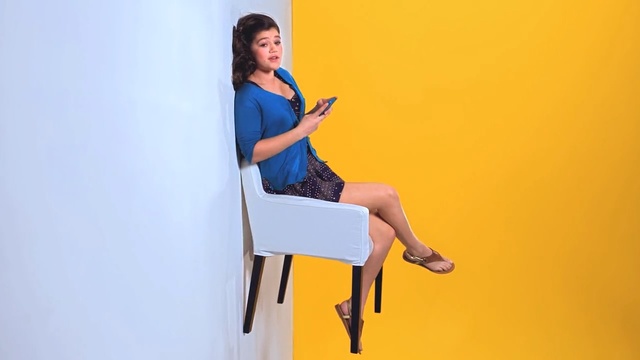Video Reference: blue, yellow, sitting, standing, leg, shoulder, furniture, arm, girl, thigh, Person