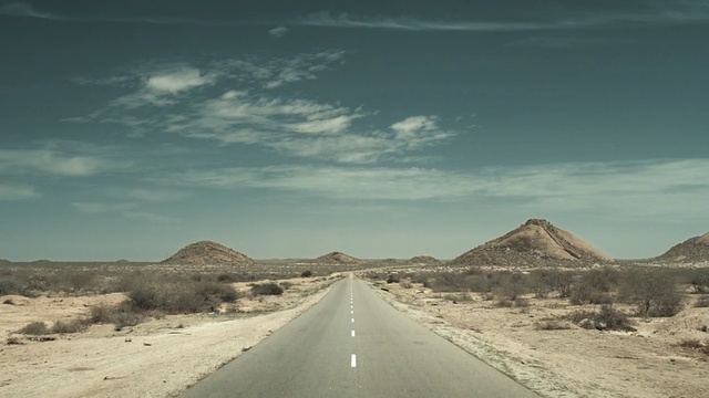 Video Reference: road, sky, cloud, horizon, desert, mountainous landforms, infrastructure, badlands, aeolian landform, road trip