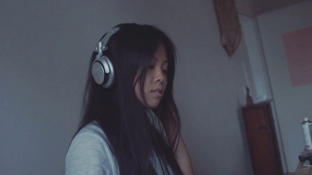 Video Reference: Hair, Face, Audio equipment, Headphones, Head, Black hair, Gadget, Technology, Electronic device, Long hair