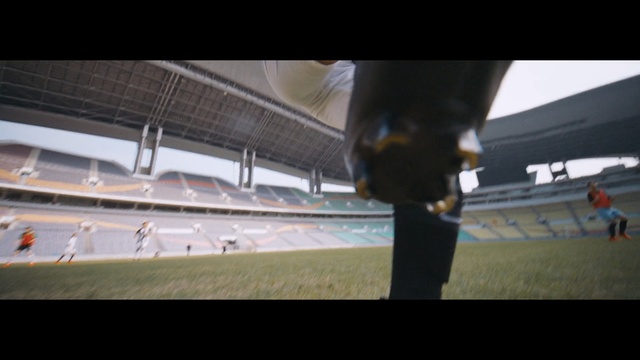 Video Reference: Sport venue, Photography, Auto part, Wheel, Stadium, Photo, Man, Sitting, Table, Standing, Woman, Jumping, White, Air, Large, Doing, Riding, Holding, Dog, Airplane, Display, Playing, Plane, Red, People, Board, Court, Ball, Trick, Blue, Player