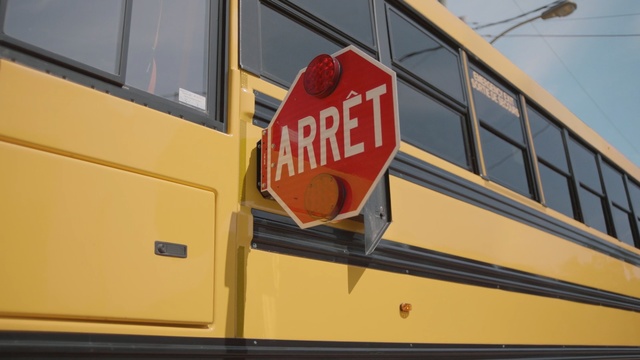 Video Reference: yellow, motor vehicle, transport, vehicle, bus, school bus, railroad car, public transport, signage, rolling stock