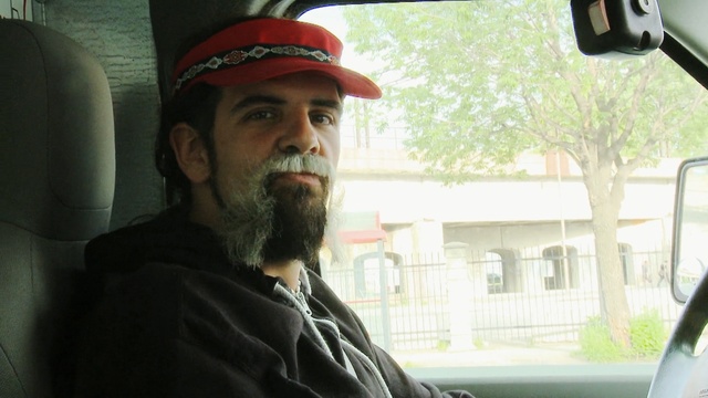 Video Reference: facial hair, beard, vehicle, car, moustache, headgear, cap, Person