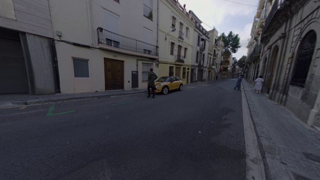 Video Reference: Road, Street, Neighbourhood, Town, Asphalt, Lane, Mode of transport, Yellow, Urban area, Human settlement, Person