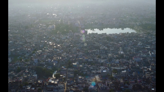 Video Reference: Metropolitan area, Aerial photography, Birds-eye view, Urban area, Cityscape, Atmospheric phenomenon, Metropolis, City, Suburb, Sky