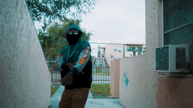 Video Reference: Green, Photograph, Cool, Snapshot, Standing, Turquoise, Photography, Games, Fun, Recreation, Building, Outdoor, Person, Holding, Man, Riding, Young, Board, Sidewalk, Ramp, Boy, Girl, Woman, Trick, Park, Walking, Doing, Shirt, Street, Playing, Game, Snow, Clothing, Tree, Sky, Cement