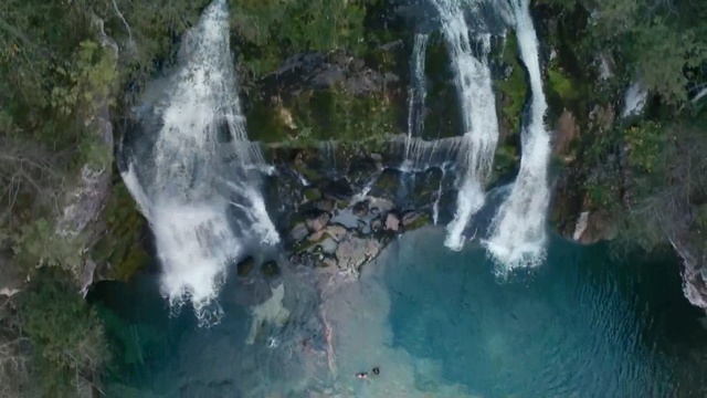 Video Reference: Waterfall, Water resources, Body of water, Natural landscape, Nature, Water, Watercourse, Nature reserve, Vegetation, Chute, Outdoor, Wave, Riding, Large, Man, Surfing, Forest, River, Standing, Young, Group, Snow, Smoke, Bear, Tree