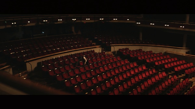 Video Reference: auditorium, theatre, performing arts center, theatre, darkness, musical instrument accessory, concert hall, night, audience