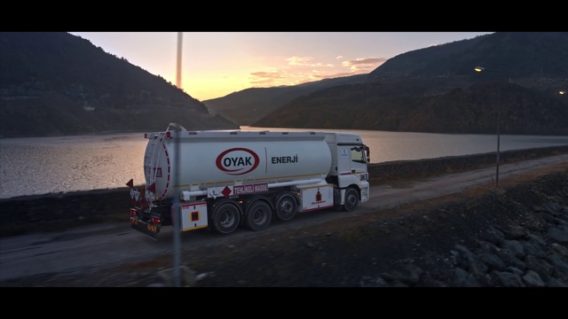 Video Reference: Wheel, Tire, Mountain, Sky, Cloud, Water, Vehicle, Automotive lighting, Natural environment, Automotive tire