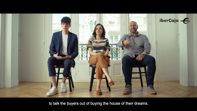 Video Reference: Sitting, Conversation, Human, Footwear, Event, Adaptation, Photography, Gentleman, Furniture, White-collar worker, Person, Man, Standing, Woman, Window, Table, People, Posing, Group, Holding, Bench, Front, Room, Display, Store, Suit, Living, White, Clothing, Text, Smile, Floor, Jeans, Human face, Trousers, High heels