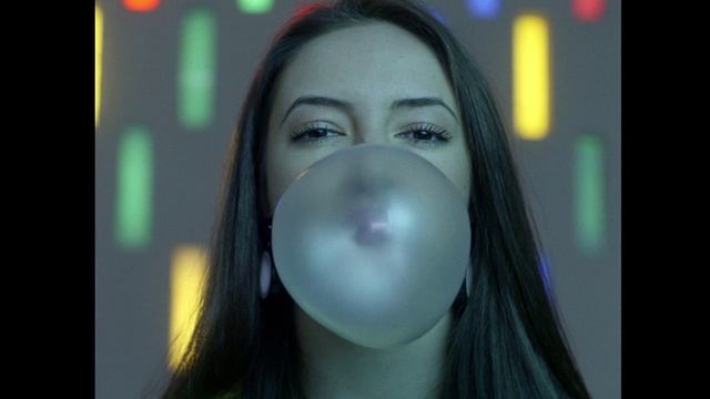 Video Reference: Face, Chewing gum, Nose, Cheek, Eyebrow, Eye, Black hair, Iris, Close-up, Photography