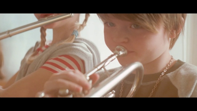 Video Reference: Child, Nose, Lip, Mouth, Musical instrument, Brass instrument, Hand, Toddler, Ear, Eyelash