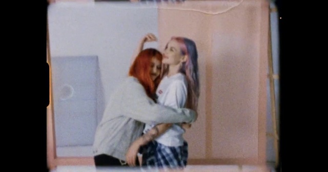 Video Reference: Gesture, Happy, Fun, Smile, Electronic device, Technology, Art, Event, T-shirt, Room