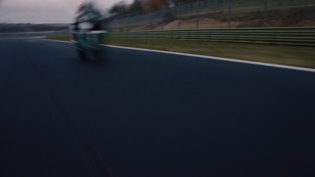 Video Reference: Asphalt, Race track, Sport venue, Sky, Road surface, Vehicle, Line, Road, Racing, Grass