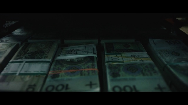 Video Reference: Money, Cash, Banknote, Text, Currency, Green, Darkness, Screenshot, Money handling, Font, Indoor, Sitting, Computer, Book, Dark, Photo, Laptop, Table, Lit, Black, Keyboard, Desk, Room, Man, White, Laying, Bed